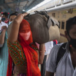 
              Travellers wait in queue to test for COVID-19 at a train station in Mumbai, India, Tuesday, Nov. 30, 2021. (AP Photo/Rafiq Maqbool)
            