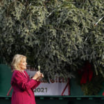 
              First lady Jill Biden takes a piece of the tree as she looks over the official White House Christmas Tree, grown in North Carolina, as it arrives at the White House in Washington, Monday, Nov. 22, 2021. (AP Photo/Susan Walsh)
            
