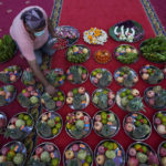 
              A devotee prepares fruits and flower offerings to Hindu Goddess Lakshmi during the Hindu festival of lights, Diwali at Vishnu temple in Bangkok, Thailand, Thursday, Nov. 4, 2021. Millions of people across Asia are celebrating the Hindu festival of Diwali, which symbolizes new beginnings and the triumph of good over evil and light over darkness. (AP Photo/Sakchai Lalit)
            