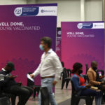 
              People wait in the observation area after receiving the Pfizer COVID-19 vaccine at the Vaccination Centre of Hope at the Cape Town International Convention Centre in Cape Town, South Africa, Tuesday, Nov. 30, 2021. (AP Photo/Nardus Engelbrecht)
            