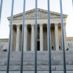 
              The U.S. Supreme Court is seen through a metal baracade on Capitol Hill in Washington, Wednesday, Nov. 3, 2021. The Supreme Court is set to hear arguments in a gun rights case that centers on New York’s restrictive gun permit law and whether limits the state has placed on carrying a gun in public violate the Second Amendment. (AP Photo/Jose Luis Magana)
            