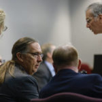 
              Defense attorney Franklin Hogue, center left, interacts with Travis McMichael at the jury selection in the trial of McMichael, William "Roddie" Bryan, and Gregory McMichael, charged with the February 2020 death of 25-year-old Ahmaud Arbery, at the Gwynn County Superior Court, in Brunswick, Ga., Wednesday, Oct. 27, 2021. (Octavio Jones/Pool Photo via AP)
            