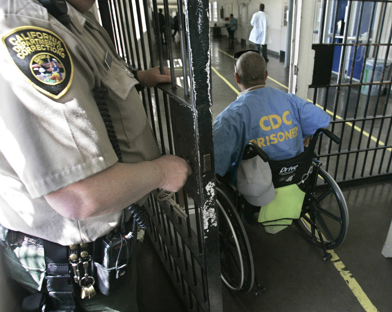 FILE - A wheelchair-bound inmate wheels himself through a checkpoint at the California Medical Faci...