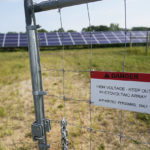 
              The entrance to a "community solar" garden bears a "Danger" message, at the farm of Barb and Gerald Bauer, in Faribault, Minn. The Bauers lease the land to Cooperative Energy Futures of Minneapolis. The cooperative develops community solar projects in the Twin Cities area. Many community solar providers are popping up around the U.S. as surging demand for renewable energy inspires new approaches. at the Bauer farm Aug. 20, 2021. (AP Photo/Jim Mone)
            