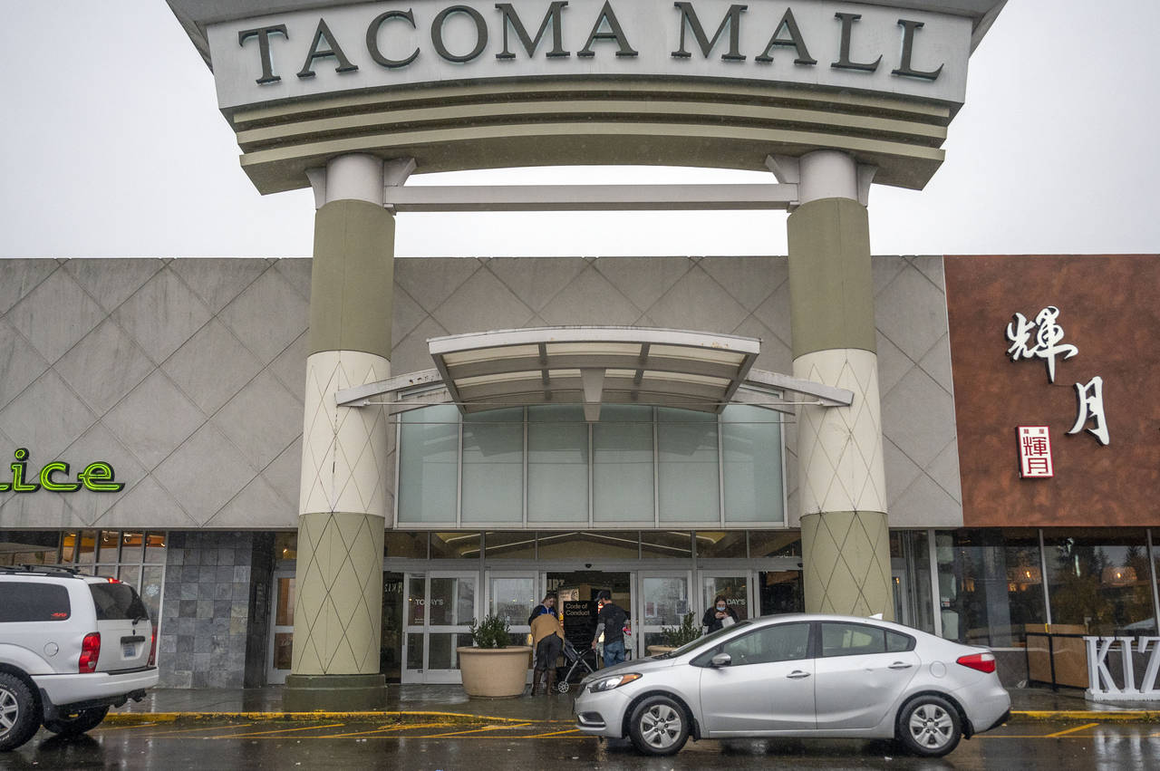 People walk into the north entrance of the Tacoma Mall, Saturday, Nov. 27, 2021, in Tacoma, Wash. A...