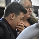 
              Kyle Rittenhouse puts his hand over his face after he is found not guilty on all counts at the Kenosha County Courthouse in Kenosha, Wis., on Friday, Nov. 19, 2021.  The jury came back with its verdict afer close to 3 1/2 days of deliberation.  (Sean Krajacic/The Kenosha News via AP, Pool)
            