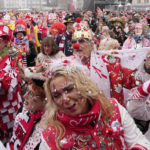 
              Carnival revellers celebrate with tens of thousands the start of the carnival season in the streets of Cologne, Germany, Thursday, Nov. 11, 2021. After carnival was cancelled last year due to the coronavirus pandemic, this year only vaccinated or recovered revellers with tickets were allowed to attend the celebrations on Cologne's central square. (AP Photo/Martin Meissner)
            