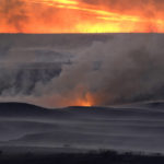 
              Grass burns in a pasture as part of a fire that burned and stretched across Ellis, Russell, Osborne and Rooks counties Thursday, Dec. 16, 2021, near Natoma, Kan. Firefighters and emergency responders are battling fires spreading across parts of central and western Kansas after a powerful storm blew through the state.  (AP Photo/Charlie Riedel)
            