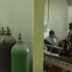 
              A woman stand next to a patient in the COVID -19 intensive care unit of the Afghan-Japan Hospital in Kabul, Afghanistan, on Thursday, Dec. 9, 2021.Afghanistan's health care system, is on the brink of collapse and able to function only with a lifeline from aid organisations. (AP Photo/ Petros Giannakouris)
            