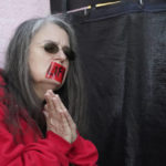 
              An abortion opponent offers silent prayer while wearing a tape across her mouth with the word "Life" written across it, while standing outside the Jackson Women's Health Organization, a state-licensed abortion clinic in Jackson, Miss., Wednesday, Dec. 1, 2021. A group of anti-abortion activists stood outside the clinic in an effort to dissuade patients from entering. On Wednesday, the U.S. Supreme Court heard a case that directly challenges the constitutional right to an abortion established nearly 50 years ago. (AP Photo/Rogelio V. Solis)
            