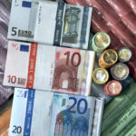 
              FILE - Euro coins and banknotes are pictured in a shop in Duisburg, Germany, Saturday, Dec. 29, 2001. The European Central Bank said Monday that it plans to redesign its euro banknotes, with a final decision on the new look expected in 2024. The euro was introduced in cash form in 2002, with banknotes based on what the Frankfurt-based central bank for the 19-nation euro area calls an 'ages and styles' theme - with generic windows, doorways and bridges that don't represent any specific place or monument. (AP Photo/Michael Sohn, file)
            
