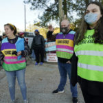 
              Pink House Defenders, from left, Alex Melick, Cory Drake, center, and Magill Grunfeld, await patients to the Jackson Women's Health Organization, a state-licensed abortion clinic in Jackson, Miss., Wednesday, Dec. 1, 2021. A small group of anti-abortion activists stood outside the clinic in an effort to dissuade patients from entering, the escorts attempt to shield them from the anti-abortion activists. On Wednesday, the U.S. Supreme Court hears a case that directly challenges the constitutional right to an abortion established nearly 50 years ago. (AP Photo/Rogelio V. Solis)
            