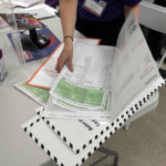 
              FILE - A poll worker assembles a ballot at Frank McCourt High School in New York's party primaries, Tuesday, June 22, 2021, in New York. New York City, long a beacon for immigrants, is on the cusp of becoming the largest place in the U.S. to give noncitizens the right to vote. Legally documented, voting-age noncitizens, who comprise nearly one in 10 of the city's 8.8 million inhabitants, would be allowed to cast votes in elections to pick the mayor, City Council members and other municipal officeholders under a bill nearing approval. (AP Photo/Richard Drew)
            