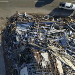 
              In this aerial photo, a collapsed factory is seen with workers searching for survivors, after tornadoes came through the area the previous night, in Mayfield, Ky., Sunday, Dec. 12, 2021. (AP Photo/Gerald Herbert)
            