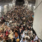 
              FILE - Afghan citizens pack inside a U.S. Air Force C-17 Globemaster III, as they are transported from Hamid Karzai International Airport in Afghanistan, on Aug. 15, 2021. America’s two-decade war and reconstruction effort in Afghanistan, which cost thousands of U.S. and Afghan lives and billions of dollars, ended in chaos and more death in August. As the remaining American troops were evacuated and those who had aided them desperately sought a way out, there were flashbacks to the fall of Saigon in 1975. (Capt. Chris Herbert/U.S. Air Force via AP, File)
            