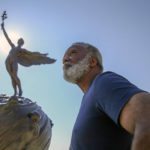 
              Reuben Green, a retired Black Naval officer, poses in front of the sculpture "Life," a memorial to those who lost their lives in World War I, at Memorial Park in Jacksonville, Fla., Friday, Feb. 26, 2021. (AP Photo/Gary McCullough)
            