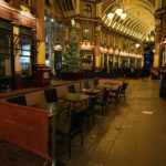 
              Empty seats outside a restaurant in London, Friday, Dec. 17, 2021. On what would normally be one of the busiest times for pubs and restaurants just before Christmas, customer numbers are down in central London due to concerns about the new omicron variant. Friday night in Central London was muted with one bar saying they have 30 customers inside when there should have been 170, with large amounts of cancellations in recent days.  (AP Photo/Alastair Grant)
            