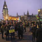 
              Anti -COVID-19 vaccination protesters demonstrate on Parliament Square in London, Saturday, Dec. 18, 2021. Hundreds of people protested in London Saturday, blocking traffic as they marched with signs bearing slogans such as “Vaccine passports kill our freedoms” and “Don’t comply.” (Ian West/PA via AP)
            