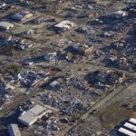 
              In this aerial photo, a collapsed factory and surrounding areas are seen in Mayfield, Ky., Sunday, Dec. 12, 2021. Tornadoes and severe weather caused catastrophic damage across multiple states Friday, killing several people overnight. (AP Photo/Gerald Herbert)
            