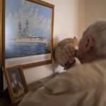 
              Pearl Harbor survivor and World War II Navy veteran David Russell, 101, looks at a painting of the USS Oklahoma while talking about the attack on Pearl Harbor on Monday, Nov. 22, 2021, in Albany, Ore. (AP Photo/Nathan Howard)
            