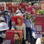 
              FILE - Protesters hold portraits of deposed Myanmar leader Aung San Suu Kyi during an anti-coup demonstration in Mandalay, Myanmar on March 5, 2021. Myanmar court on Monday, Dec. 6, 2021, sentenced ousted leader Suu Kyi to 4 years for incitement and breaking virus restrictions, then later in the day state TV announced that the country's military leader reduced the sentence by two years. (AP Photo/File)
            