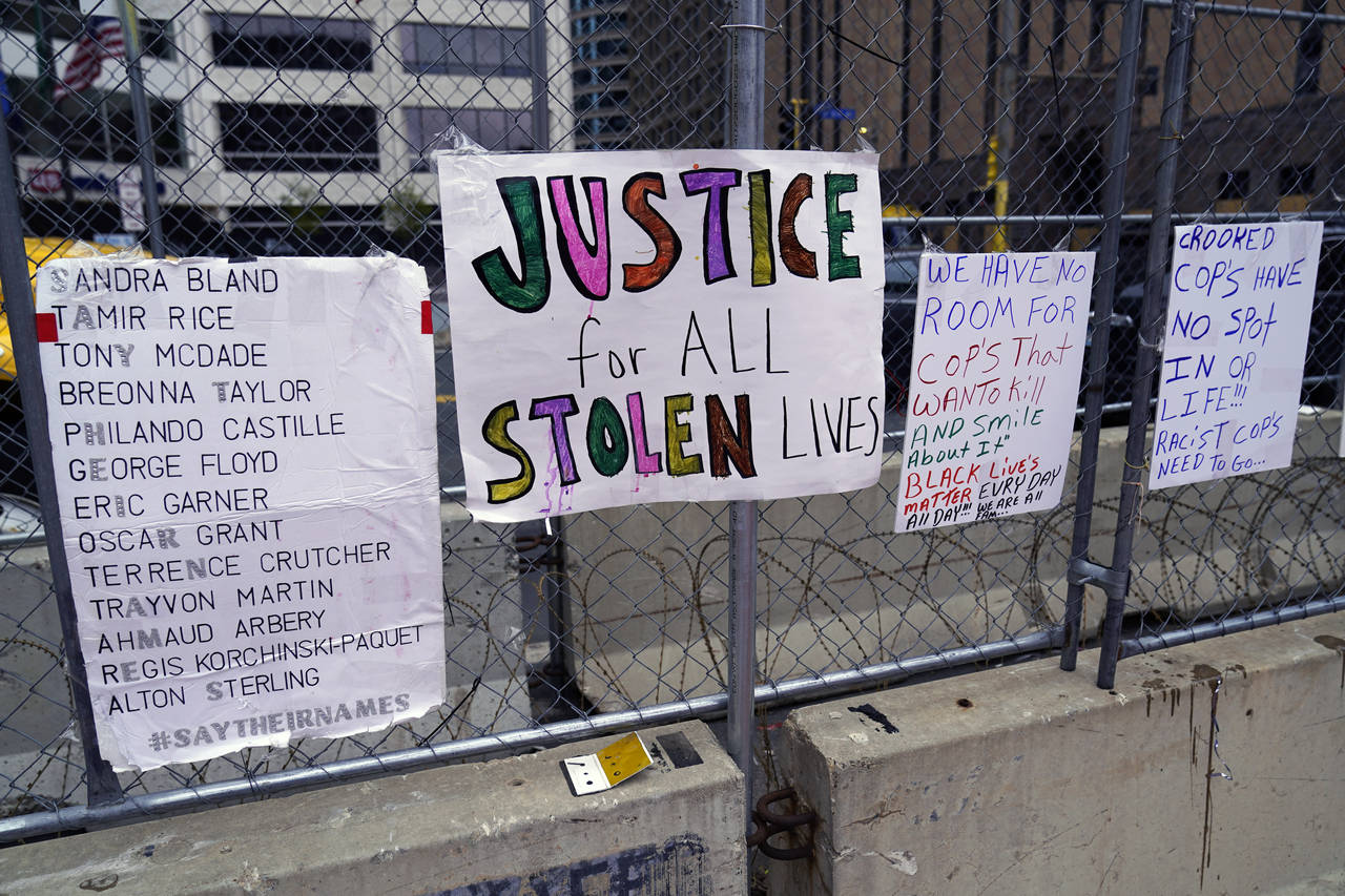 New signs are on a fence at the Hennepin County Government Center, Monday, April 19, 2021, in Minne...