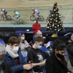 
              People wait after beeing vaccinated as riders train at the National Velodrome in Saint-Quentin-en-Yvelines, west of Paris, France, Friday, Dec. 17, 2021. The government is holding a special virus security meeting Friday to address growing pressure on hospitals in France from rising infections. (AP Photo/Christophe Ena)
            