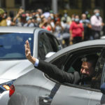 
              Chilean President-elect Gabriel Boric waves to supporters as he arrives to La Moneda presidential palace for a meeting with current President Sebastian Pinera in Santiago, Chile, Monday, Dec. 20, 2021. (AP Photo/Matias Delacroix)
            