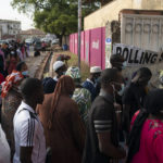 
              People line up to cast their ballot for Gambia's presidential elections, in Banjul, Gambia, Saturday, Dec. 4, 2021. Lines of voters formed outside polling stations in Gambia’s capital as the nation holds a presidential election. The election on Saturday is the first in decades without former dictator Yahya Jammeh as a candidate. (AP Photo/Leo Correa)
            