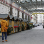 
              Two people walk by closed Christmas markets and shops due to the lockdown in Vienna, Austria, Tuesday, Nov. 30, 2021. (AP Photo/Lisa Leutner)
            