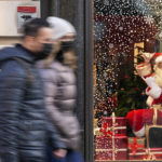 
              A man dressed as Santa Claus gestures as people walk past, in London, Saturday, Dec. 4, 2021. Britain says it will offer all adults a booster dose of vaccine within two months to bolster the nation's immunity as the new omicron variant of the coronavirus spreads. New measures to combat variant came into force in England on Tuesday, with face coverings again compulsory in shops and on public transport. (AP Photo/Alberto Pezzali)
            