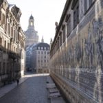 
              A passer-by walks along the empty Augustusstrasse next to the 'Fuerstenzug' mural in front of the Frauenkirche in Dresden, Germany, Thursday, Dec. 2, 2021. Germany's outgoing Chancellor Angela Merkel and her likely successor met with state governors to consider tighter rules to curb coronavirus infections. The rise in COVID-19 cases over the past weeks and the arrival of the new omicron variant have prompted warnings from scientists and doctors that medical services in the country could become overstretched in the coming weeks unless drastic action is taken. Photo: Sebastian Kahnert/dpa via AP)
            