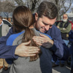 
              Kentucky Gov. Andy Beshear gives a hug to Bremen Volunteer Junior Fire Department member Brehanna Lee, Tuesday, Dec. 14, 2021, in Bremen, Ky, while touring the community to view the destruction from a tornado that struck the area several days earlier. (Greg Eans/The Messenger-Inquirer via AP)
            