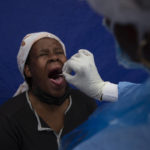 
              FILE — A throat swab is taken from a patient to test for COVID-19 at a facility in Soweto, South Africa, Dec. 2, 2021. Health experts still don't know if omicron is causing milder COVID-19 but some more hints are emerging with doctors in South Africa saying their patients aren't getting as sick with omicron, compared to the delta variant. (AP Photo/Denis Farrell;File)
            