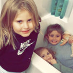 
              In this Dec. 10, 2021, photo provided by Sandra Hooker, from left, Avalinn Rackley, 7, Alanna Rackley, 3, and Annistyn Rackley, 9, pose for a picture in a bathroom in their home near Caruthersville, Missouri. Annistyn, a third-grader who loved swimming, dancing and cheerleading, was among dozens of people who died because of the severe storm on Friday, Dec. 10. A tornado hit her home and splintered it less than a week after the family had moved in, and, according to the relative who received the photo of the girl in the bathtub, it carried family members dozens of yards before dropping them in a muddy field. (Meghan Rackley/Courtesy of Sandra Hooker via AP)
            