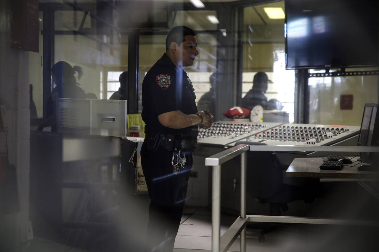 FILE - A corrections officer watches monitors at a security post in an enhanced supervision jail un...