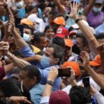 
              Opposition leaders Juan Guaido, center left, and Freddy Superlano, greet supporters during a demonstration in support of Superlano, in Barinas, Venezuela, Saturday, Dec. 4, 2021. Superlano, who was leading the race for governor in Barinas State in the recent Nov. 21 regional elections, called for a protest this Saturday after a court ruling ordered new elections in the state and disqualified him from running.  (AP Photo/Ariana Cubillos)
            