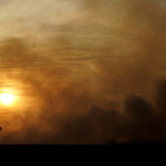 
              A windmill is silhouetted against smoke from a fire that burned and stretched across Ellis, Russell, Osborne and Rooks counties Thursday, Dec. 16, 2021, near Natoma, Kan. Firefighters and emergency responders are battling fires spreading across parts of central and western Kansas after a powerful storm blew through the state.  (AP Photo/Charlie Riedel)
            