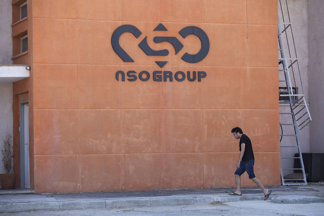 FILE - A logo adorns a wall on a branch of the Israeli NSO Group company, near the southern Israeli...