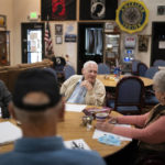 
              Pearl Harbor survivor and World War II Navy veteran David Russell, 101, center, talks with Karen Wilson, right, and other veterans while eating breakfast at the American Legion Post 10 on Monday, Nov. 22, 2021, in Albany, Ore. (AP Photo/Nathan Howard)
            