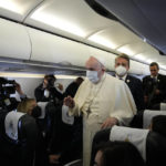 
              Pope Francis speaks during a news conference onboard the papal plane on the occasion of his five-day pastoral visit to Cyprus and Greece, Thursday, Dec. 2, 2021.(AP Photo/Alessandra Tarantino, Pool)
            