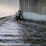 
              A vehicle is seen in the Los Angeles River at the Washington Bridge near downtown Los Angeles on Tuesday, Dec. 14, 2021. Rain is drenching Southern California as a blustery storm charged down the state, triggering river rescue efforts and raising the threat of mudslides in areas scarred by wildfires. (AP Photo/Ringo H.W. Chiu)
            