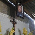 
              A portrait of Guatemalan migrant Daniel Arnulfo Perez Uxla, 41, hangs over his remains during his wake in El Tejar, Guatemala, Sunday, Dec. 19, 2021. Perez Uxla was one of the fifty-six people killed when a truck carrying Central American migrants rolled over on a highway in Tuxtla, Mexico, on Dec. 9. (AP Photo/Moises Castillo)
            