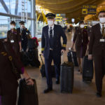 
              Flight crew members wearing face masks to prevent the spread of coronavirus walk along the Adolfo Suarez-Barajas international airport in Madrid, Spain, Thursday, Dec. 2, 2021. The coronavirus's omicron variant kept a jittery world off-kilter as reports of infections linked to the mutant strain cropped up in more parts of the globe. (AP Photo/Manu Fernandez)
            