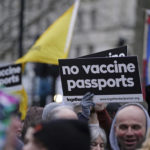 
              Anti -COVID-19 vaccination protesters demonstrate on Whitehall near Downing Street, in London, Saturday, Dec. 18, 2021. Hundreds of people protested in London Saturaday,  blocking traffic as they marched with signs bearing slogans such as “Vaccine passports kill our freedoms” and “Don’t comply.” (Ian West/PA via AP)
            