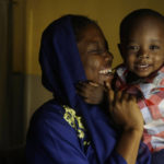 
              Amina Ahmed, the wife of Muhammad Mubarak Bala, an atheist who has been detained since April 2020, plays with her son, Sodangi Mubarak, in her home in Abuja, Nigeria, Sunday, Nov. 21, 2021. Bala’s lengthy detention and its traumatic effect on his young family illustrate the risks of being openly faithless in African countries where belief looms large in social and political life and challenging such norms is taboo. (AP Photo/Sunday Alamba)
            