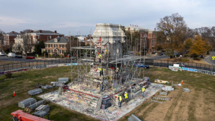 Workers install scaffolding as they prepare to remove the pedestal that once held the statue of Con...