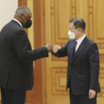 
              South Korean President Moon Jae-in, right, bumps elbows with U.S. Defense Secretary Lloyd Austin before their meeting at the presidential Blue House in Seoul, South Korea, Thursday, Dec. 2, 2021. Austin said Thursday that China's pursuit of hypersonic weapons "increases tensions in the region" and vowed the U.S. would maintain its capability to deter potential threats posed by China. (Ahn Jung-hwan/Yonhap via AP)
            