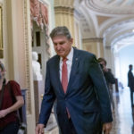 
              Sen. Joe Manchin, D-W.Va., a centrist Democrat vital to the fate of President Joe Biden's $3.5 government overhaul, walks to a caucus lunch at the Capitol in Washington, Friday, Dec. 17, 2021. Despite months of being courted and cajoled, Manchin is still not a yes on President Joe Biden's big $2 trillion domestic package and has thrown Democrats into turmoil. (AP Photo/J. Scott Applewhite)
            