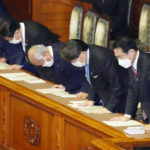 
              Japanese Prime Minister Fumio Kishida, right, bows with his cabinet ministers as the supplementary budget for the fiscal year was approved at the House of Councilors in Tokyo, Monday, Dec. 20, 2021. Japan’s parliament on Monday approved a record extra budget of nearly 36 trillion yen ($317 billion) for the fiscal year through March to help out pandemic-hit households and businesses.(Kyodo News via AP)
            